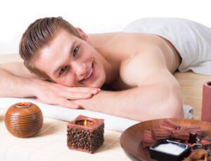 Handsome man lying on the massage desks.